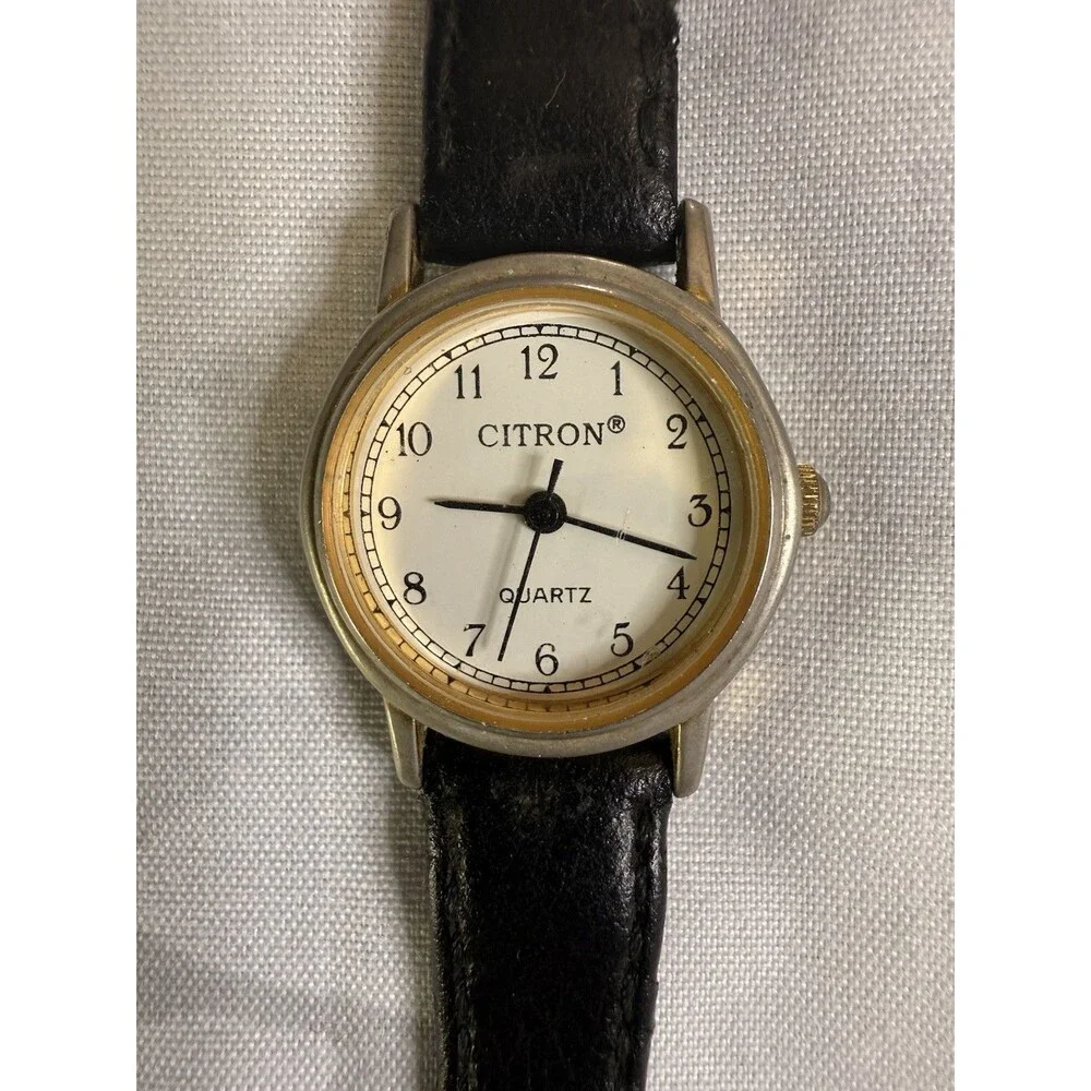Citron Vintage Women’s Watch, White dial and gold casing. Black leather band.